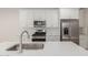 This bright kitchen features an island sink, stainless steel appliances and white cabinetry at 2917 N Evergreen St, Buckeye, AZ 85396