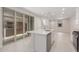 Open floor plan featuring a kitchen island, stainless appliances, white cabinetry and sliding glass doors at 2917 N Evergreen St, Buckeye, AZ 85396
