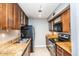 Well-equipped galley kitchen featuring dark wood cabinets at 3600 N Hayden Rd # 3101, Scottsdale, AZ 85251