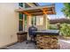 Outdoor kitchen showcases built-in grill with countertop and brick accents, perfect for outdoor entertaining at 3626 E Sagittarius Pl, Chandler, AZ 85249