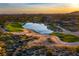 Golf course community with lake and homes at sunset at 38300 N 102Nd St, Scottsdale, AZ 85262