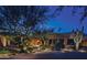 Stunning desert home with beautiful landscaping at night at 38300 N 102Nd St, Scottsdale, AZ 85262