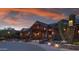Clubhouse exterior with wood and stone accents at dusk at 38300 N 102Nd St, Scottsdale, AZ 85262