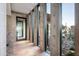Modern hallway with concrete walls and large windows to a garden at 38300 N 102Nd St, Scottsdale, AZ 85262