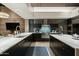Modern kitchen with marble countertops, a center island, and professional-grade appliances at 38300 N 102Nd St, Scottsdale, AZ 85262