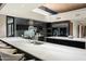 Spacious gourmet kitchen featuring marble countertops, a long breakfast bar, and modern appliances at 38300 N 102Nd St, Scottsdale, AZ 85262