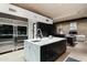 Modern kitchen with stainless steel appliances, marble countertop island and dark wood cabinets at 38300 N 102Nd St, Scottsdale, AZ 85262