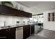 Sleek, modern kitchenette features stainless steel appliances and dark cabinetry at 38300 N 102Nd St, Scottsdale, AZ 85262
