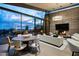 Open-concept living room with floor-to-ceiling windows, a fireplace, and contemporary furnishings at 38300 N 102Nd St, Scottsdale, AZ 85262