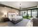 Inviting main bedroom offering modern chandelier and views of the private courtyard at 38300 N 102Nd St, Scottsdale, AZ 85262