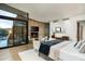 Open main bedroom featuring fireplace, desert view, and modern style at 38300 N 102Nd St, Scottsdale, AZ 85262