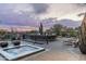 Modern patio featuring a hot tub, stylish outdoor seating, desert views, and a sleek metal fence for upscale relaxation at 38300 N 102Nd St, Scottsdale, AZ 85262