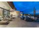 Patio with desert view and architectural home design, including a pool and ample seating at 38300 N 102Nd St, Scottsdale, AZ 85262