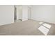 Neutral bedroom with carpet flooring, ensuite bathroom, and ample closet space at 4041 S 176Th Dr, Goodyear, AZ 85338