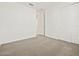 An empty bedroom with carpet and a closet with sliding doors at 4041 S 176Th Dr, Goodyear, AZ 85338