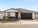 Charming single-story home featuring a dark brown garage door and neutral-toned stucco exterior at 4041 S 176Th Dr, Goodyear, AZ 85338