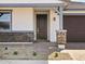 Inviting front entrance with stone accents, a dark wood door, and a well-maintained walkway at 4041 S 176Th Dr, Goodyear, AZ 85338