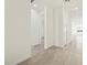Bright hallway with tile flooring, white walls, and a view of the open-concept living space at 4041 S 176Th Dr, Goodyear, AZ 85338