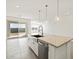 Kitchen island featuring a stainless steel dishwasher, sink, and stylish pendant lighting at 4041 S 176Th Dr, Goodyear, AZ 85338