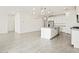 Open concept kitchen features large island, stainless appliances, and modern lighting at 4041 S 176Th Dr, Goodyear, AZ 85338