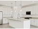 Modern kitchen with white cabinets, granite countertops, stainless steel appliances, and pendant lighting at 4041 S 176Th Dr, Goodyear, AZ 85338
