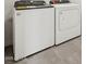 White Whirlpool washer and dryer on gray tile flooring at 4041 S 176Th Dr, Goodyear, AZ 85338