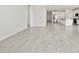 Spacious living room with light tile flooring leading to the modern kitchen at 4041 S 176Th Dr, Goodyear, AZ 85338