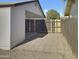 Small patio area next to the house with a wooden fence and a covered area at 4619 W Mission Ln, Glendale, AZ 85302