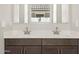 Bathroom vanity with dual sinks, modern fixtures and dark cabinets at 4822 N 177Th Ln, Goodyear, AZ 85395