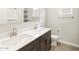Bathroom with dual sinks, dark wood cabinets, tile floors, and a walk-in shower at 4822 N 177Th Ln, Goodyear, AZ 85395