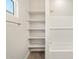 Bright bathroom featuring a tiled shower/tub and open shelf for storage at 4822 N 177Th Ln, Goodyear, AZ 85395