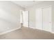 A bright bedroom features neutral carpet and a closet with sliding doors for ample storage at 4822 N 177Th Ln, Goodyear, AZ 85395