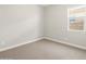 A cozy bedroom featuring neutral carpet, white walls, and a window for natural light at 4822 N 177Th Ln, Goodyear, AZ 85395