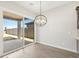 Dining area with modern light fixture, tile floors, and access to the covered patio at 4822 N 177Th Ln, Goodyear, AZ 85395
