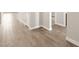 Hallway with neutral colored tile flooring and white baseboards at 4822 N 177Th Ln, Goodyear, AZ 85395