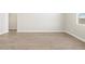 Unfurnished living room with neutral walls, tile floors, and bright natural light at 4822 N 177Th Ln, Goodyear, AZ 85395