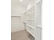 Bright walk-in closet with built-in shelving and carpeted floors at 4822 N 177Th Ln, Goodyear, AZ 85395