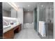 Modern bathroom with double vanity, soaking tub, and glass shower at 5455 E Lincoln Dr # 1001, Paradise Valley, AZ 85253