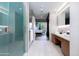 Spa-like bathroom with walk-in shower, double vanity, and views into bedroom at 5455 E Lincoln Dr # 1001, Paradise Valley, AZ 85253