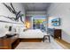 Spacious bedroom with king-size bed, large TV and private patio access at 5455 E Lincoln Dr # 1001, Paradise Valley, AZ 85253