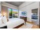 Bright bedroom with king bed, access to private patio, and living area view at 5455 E Lincoln Dr # 1001, Paradise Valley, AZ 85253