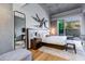 Main bedroom with a king-size bed and access to private patio at 5455 E Lincoln Dr # 1001, Paradise Valley, AZ 85253