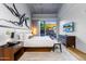 Spacious bedroom with king-size bed, private patio access, and modern TV at 5455 E Lincoln Dr # 1001, Paradise Valley, AZ 85253