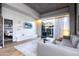 Spacious living room with hardwood floors, large TV and access to patio at 5455 E Lincoln Dr # 1001, Paradise Valley, AZ 85253