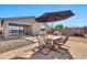 Backyard patio with table, chairs, umbrella, and grill at 5932 S 26Th Ave, Phoenix, AZ 85041