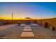 Landscaped backyard with patio, table, umbrella, and grill at 5932 S 26Th Ave, Phoenix, AZ 85041