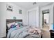 Cozy bedroom with full bed, closet, and adjacent hallway at 5932 S 26Th Ave, Phoenix, AZ 85041