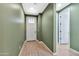 Light and airy entryway with green walls and wood-look tile at 5932 S 26Th Ave, Phoenix, AZ 85041