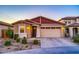One-story home with a two-car garage and desert landscaping at 5932 S 26Th Ave, Phoenix, AZ 85041