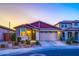 House exterior at dusk with a two car garage at 5932 S 26Th Ave, Phoenix, AZ 85041